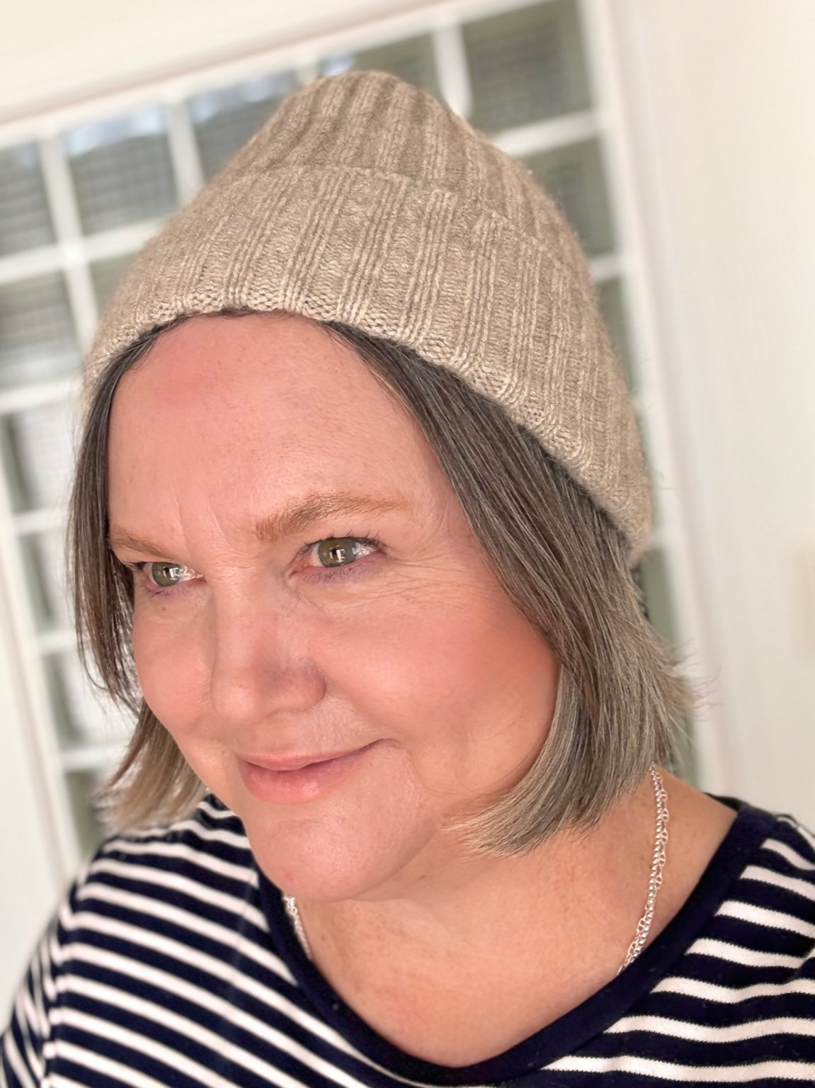 shop owner modeling a beanie