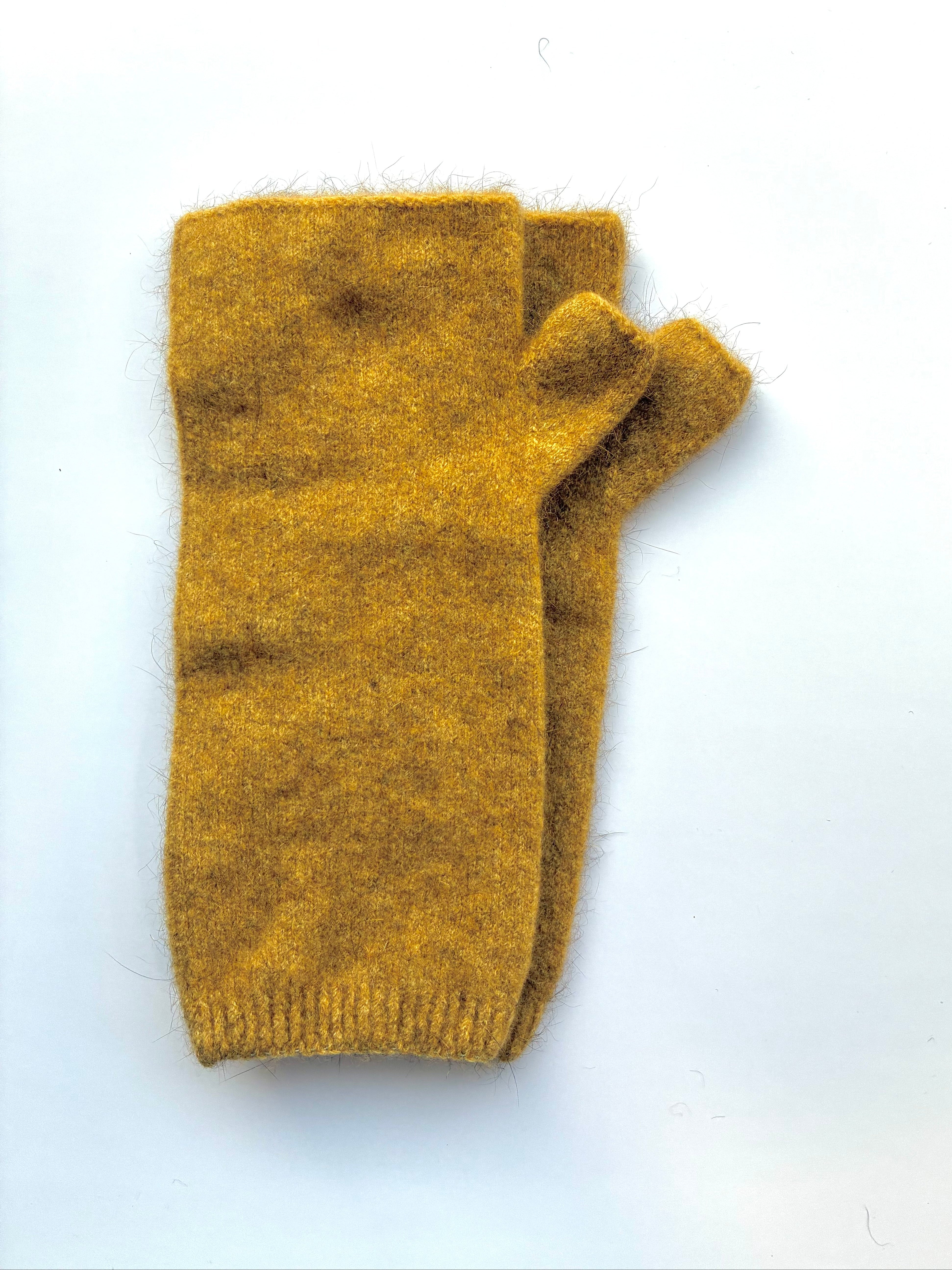 Marigold yellow knitted wristwarmers on a white background